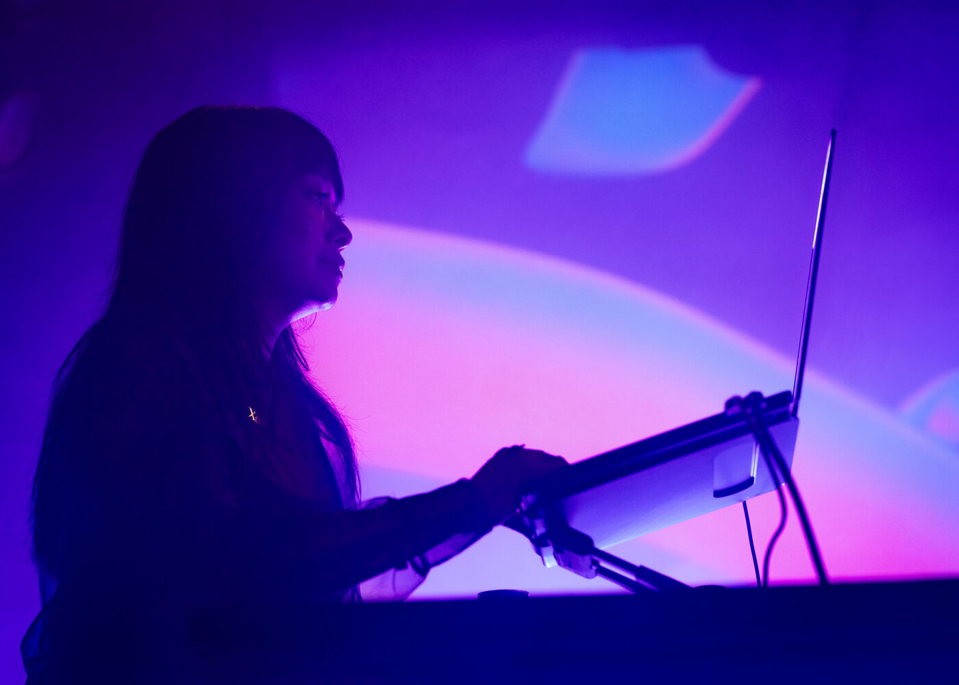 ephemeral objects performing live, in silhouette